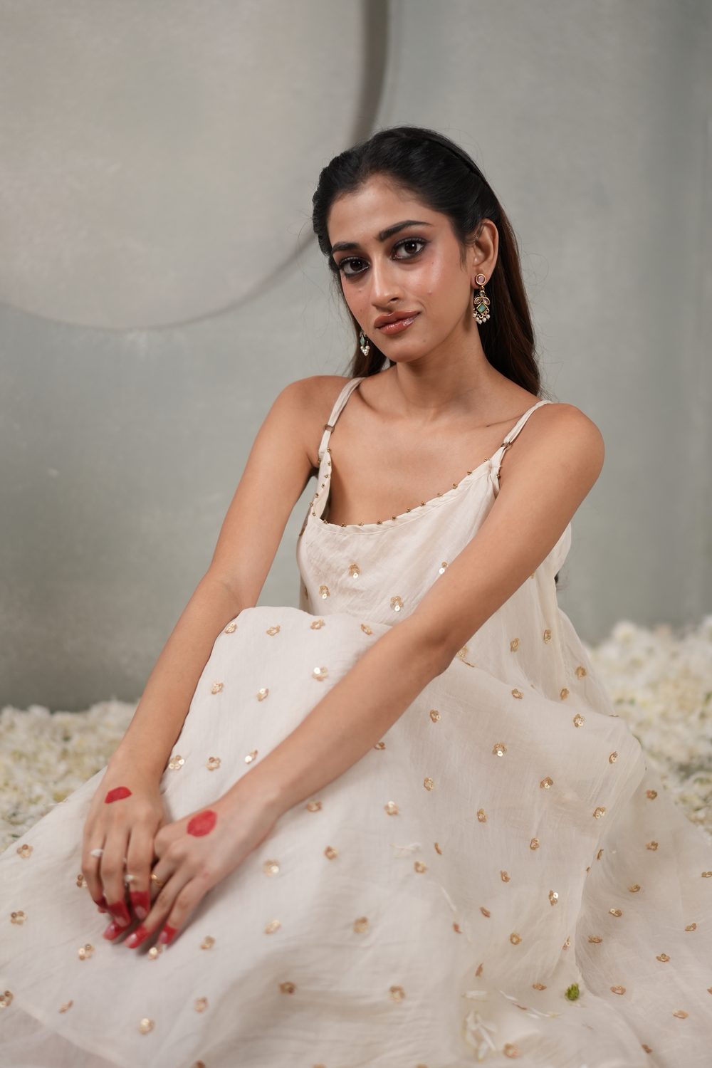Sitara Swirl Ivory asymmetric dress — seated portrait
