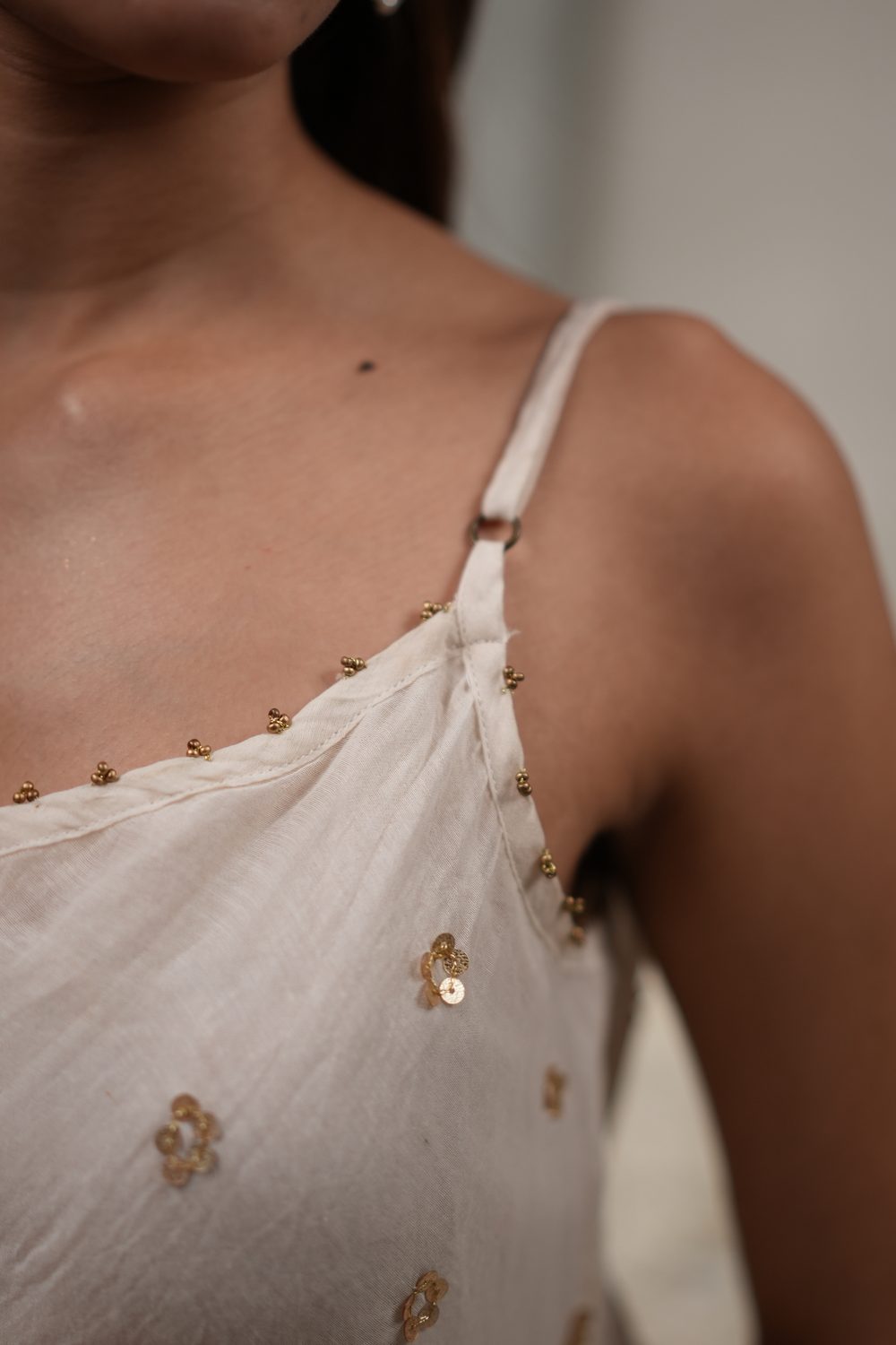 Sitara Swirl Ivory asymmetric dress — neckline detail